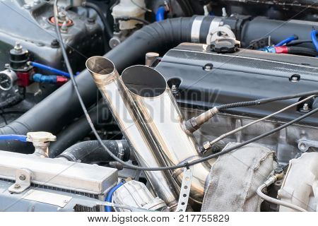 race car exhaust stand less  pipes in garage