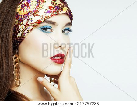 young pretty modern girl with bright shawl on head and makeup emotional posing isolated on white background, lifestyle people concept copyspace