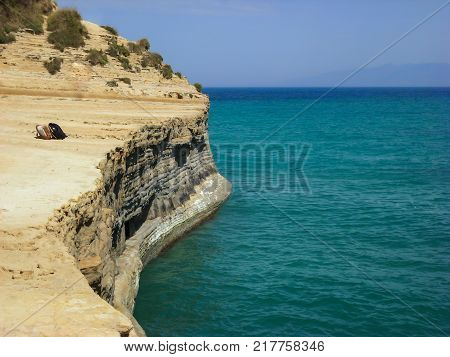 Sidari Corfu Greece - rocky cliff with backpacks and beautiful turquoise water