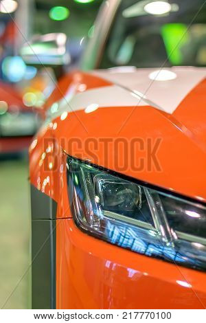 red racing sports car shines and shimmers in the lights of the auto show