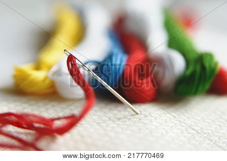 Needle In Canvas With Red Thread For Embroidery. Embroidery Macro Close Up. View From Above. Free Co