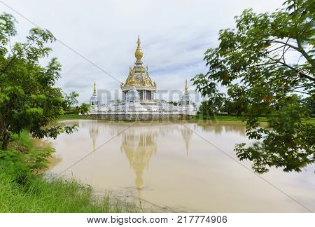 Magnificent Wat Thung Setthi (The Great Jewel Chedi of the three worlds) in beautiful day and reflection Khon Kaen Thailand