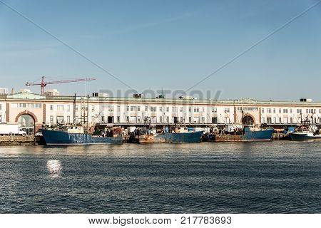 View of harbor from the Boston Waterfront with fishing boat trucks and boats anchored Massachusets USA