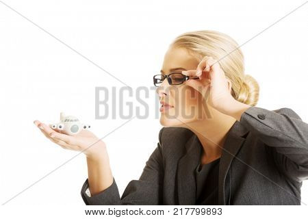 Businesswoman with plane toy in hand