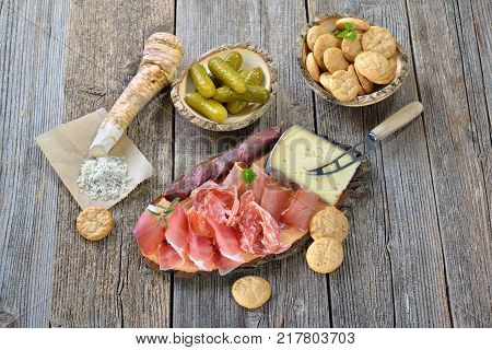 South Tyrolean snack with bacon, salami, red wine cheese, herb ham, fresh horseradish and local crunchy rye bread
