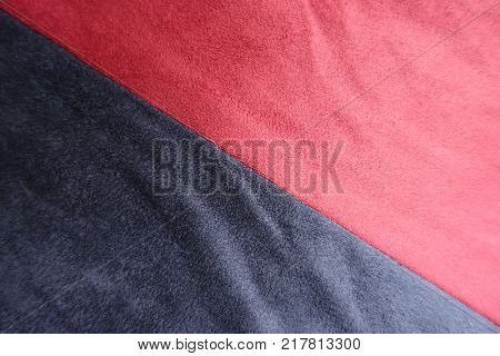 Diagonal seam between red and dark blue artificial suede