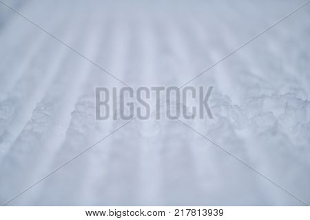 Texture of fresh stripped snowcat traces on snow