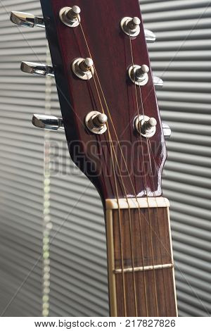 Close up to the tuning keys of an acoustic guitar