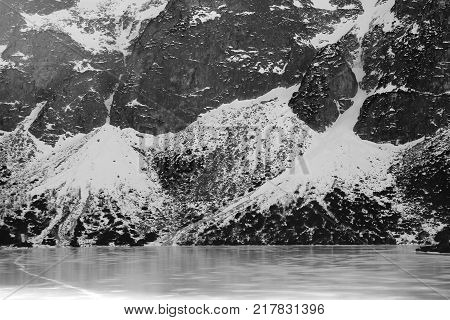 Black and white panorama of winter mountains. view from frozen lake. Morskie oko Tatra Poland