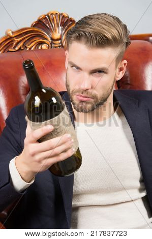 Man Degustator With Beard, Stylish Hair Hold Wine Bottle