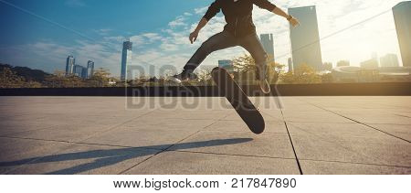 female skateboarder jumping on city with skateboard