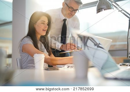 Manager talking to co-worker about sales target