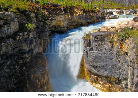 Roaring waterfall from Tokumm Creek at Marble Canyon hike in Kootenay National Park British Columbia Canada near Banff.