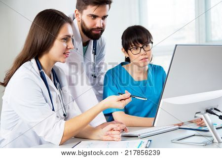 Group of doctors in the hospital discuss the diagnos of the patient