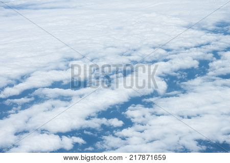 cloud scape on blue sky background from airplane window