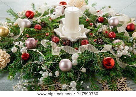Decorated Advent wreath with white candles on blue wooden background useful as christmas decoration