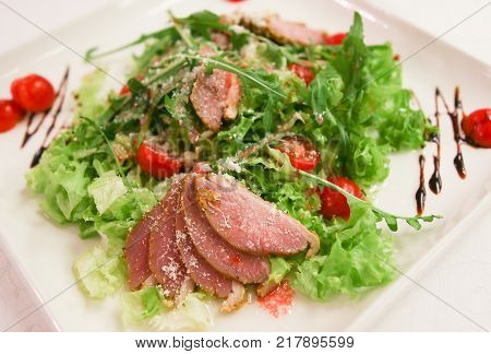 fresh lettuce from greenery of meat on a white dish from chief of cook