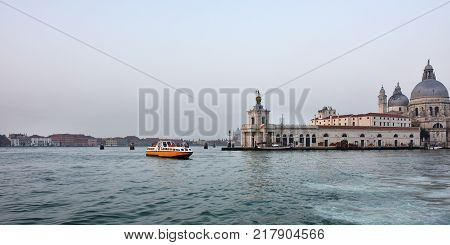 View from the Grand Canal on Dogana da Mar or Dogana di Mare building where the Grand Canal meets the Giudecca Canal in Venice Italy.
