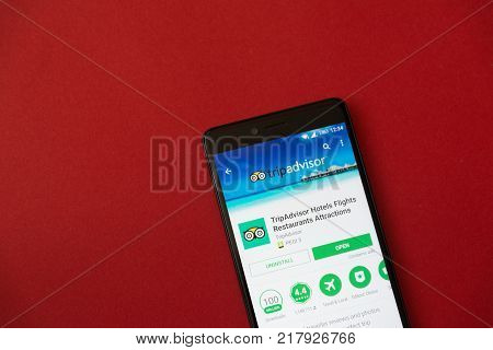 Los Angeles, december 11, 2017: Smartphone with Tripadvisor application in google play store on red background