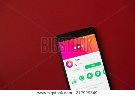 Los Angeles, december 11, 2017: Smartphone with Tinder application in google play store on red background