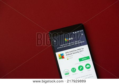 Los Angeles, december 11, 2017: Smartphone with AVG application in google play store on red background