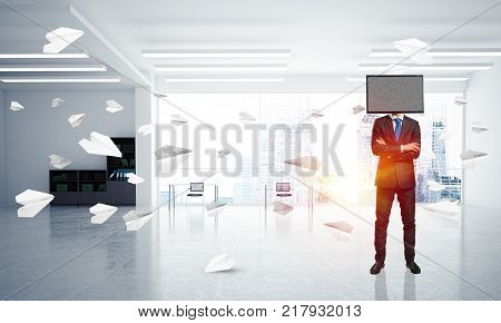 Businessman in suit with TV instead of head keeping arms crossed while standing among flying paper planes inside office building. 3D rendering.