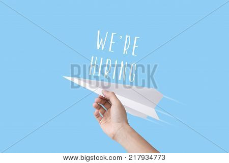 hand holding rocket with we're hiring text. concept employment recruitment hiring.