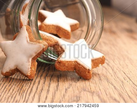 Star shaped cinnamom cookies on a wooden table close up Christmas sweets
