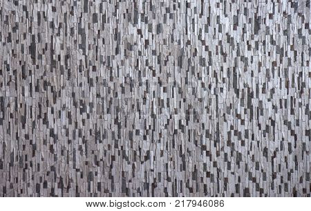 Decorative brick wall from concrete facing tiles as background or texture.