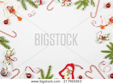 Christmas holiday composition. Festive creative pattern, xmas red decor holiday ball with Christmas candy canes, gift, snowflakes, christmas tree on white background. Flat lay, top view