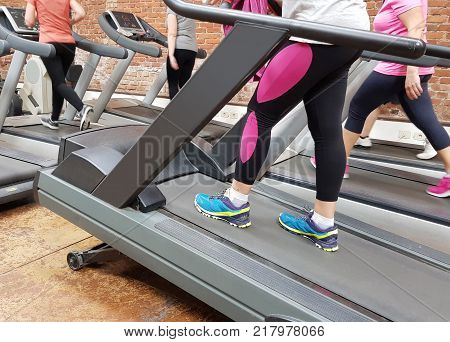 some different woman walk on the speedwalk