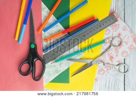 pens pencils markers notebook scissors. Top view