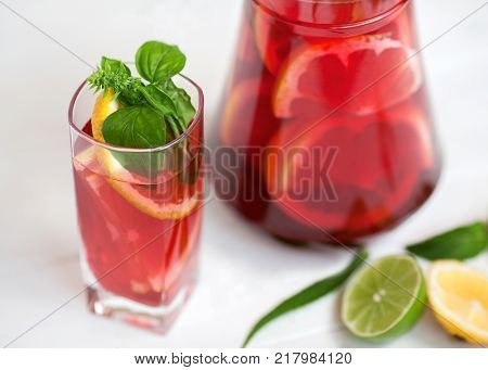 tasty and juicy sangria with citrus in a glass on a white background