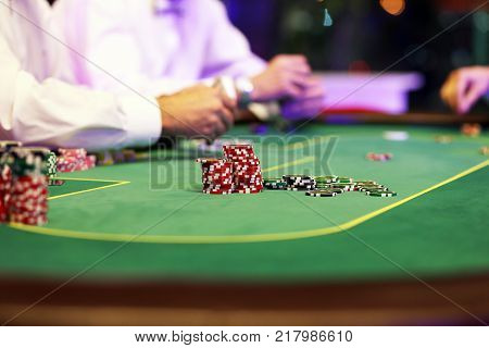 Casino card game with chips on a green background
