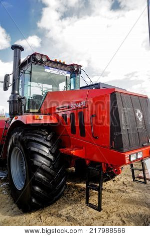 Tyumen, Russia - April 04. 2014: IV Tyumen specialized exhibition Agricultural Machinery and Equipment. Tractors demonstration of Kirovskiy Factory production on platform open-air