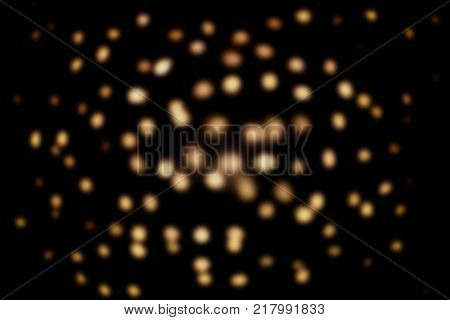 Festive lights overlay. Golden blurred cirkles on black background.