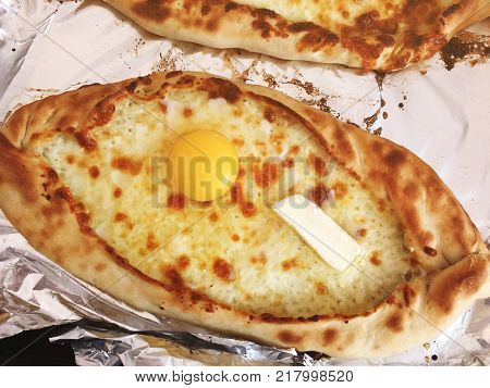 Adjarian khachapuri, open bread stuffed with cheese and egg yolk. Khachapuri is a traditional dish of Georgian cuisine.