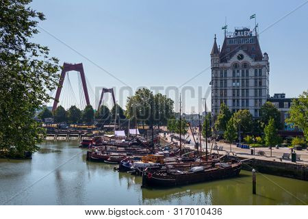 Rotterdam, Holland - July 30, 2019: Oude Haven, Old Port, part of the Maritime District with historical ships, with the white house on the background
