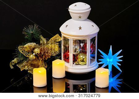 Christmas Still Life With A Flashlight Candles And A Spruce Branch