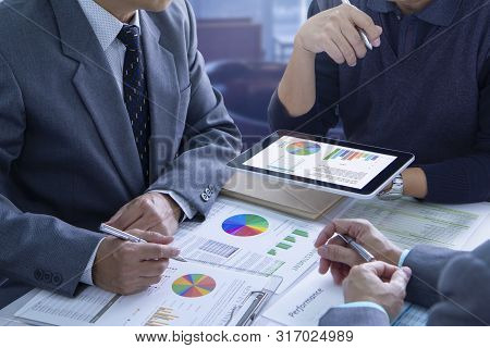 Businessmen Are Deeply Reviewing Financial Reports For A Return On Investment Or Investment Risk Ana