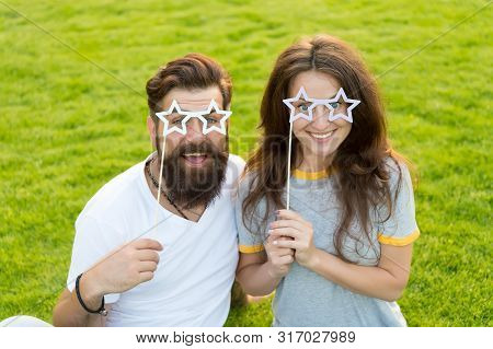Fun Props. Funny Couple Holding Star-shaped Photobooth Props On Sticks. Happy Family Celebrating Wit