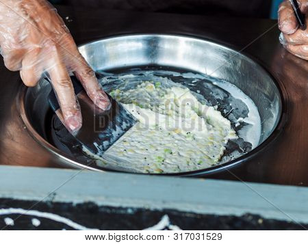 Making Rolled Ice Cream. Man Hands Making Kiwi And Banana Thay Style Natural Ice Cream