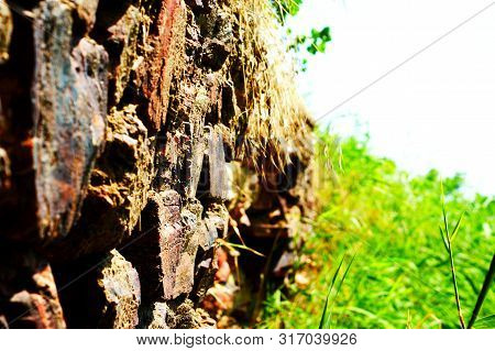 Ancient Stone Wall Near The River Near The Reeds