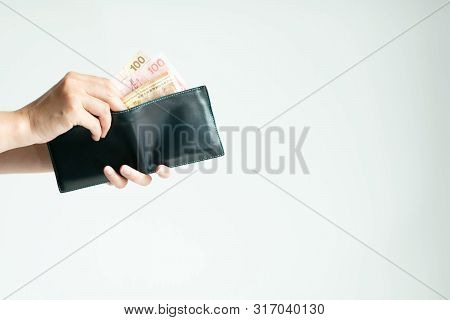 Hands Holding A Short Wallet And One Hand Bring Out Hong Kong Money ;in Currency Of Dollar Hong Kong