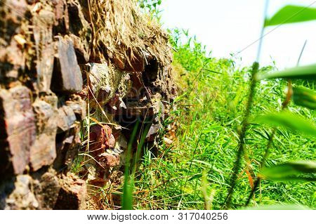 Ancient Wall Made Of Large Stones Of Iron Ore Bonded.