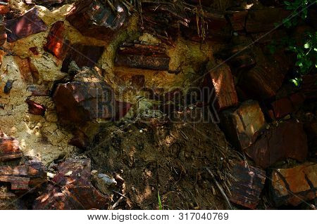 Ancient Wall Made Of Large Stones Of Iron Ore Bonded.