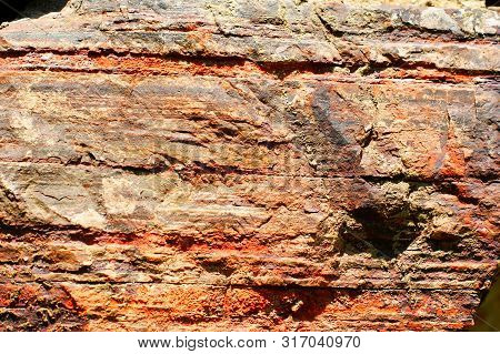 Ancient Wall Made Of Large Stones Of Iron Ore Bonded.
