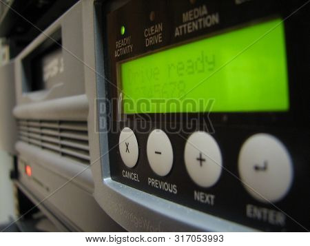 Servers Stack With Disc Drives In A Rack And Glowing Lights