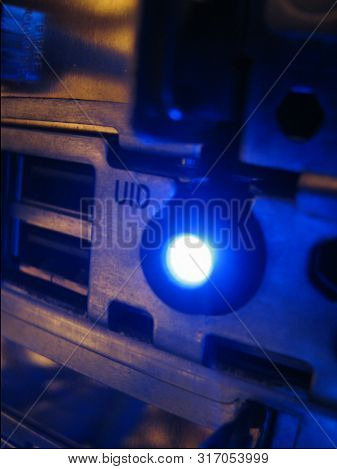 Servers Stack With Disc Drives In A Rack And Glowing Lights