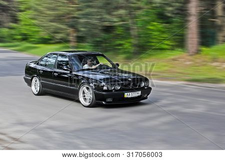 Kiev, Ukraine. May 17, 2014. Bmw M5 (e34) Against The Background Of The Forest. The Car Is On The Mo